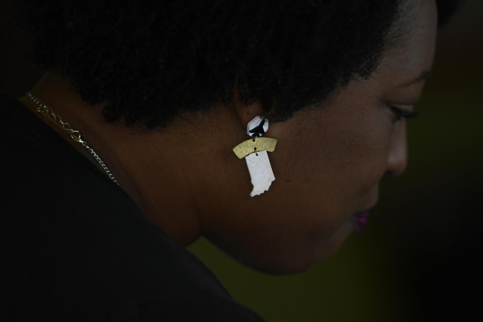 Jennifer-Ruth Green, the Republican candidate for Indiana's 1st Congressional District and an U.S. Air Force veteran, talks to supporters while wearing earrings representing Indiana and fighter jets before a roundtable meeting Thursday, Oct. 20, 2022, in Gary, Ind. (AP Photo/Paul Beaty)