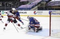 New Jersey Devils' Jack Hughes (86) scores against New York Rangers goalie Alexandar Georgiev during the second period of an NHL hockey game Tuesday, Jan. 19, 2021, in New York. (Bruce Bennett/Pool Photo via AP)