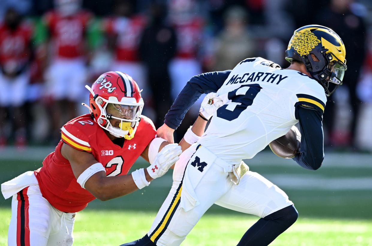 J.J. McCarthy of the Michigan Wolverines is tackled by Beau Brade of the Maryland Terrapins in the second quarter at SECU Stadium in College Park, Maryland, Nov. 18, 2023.