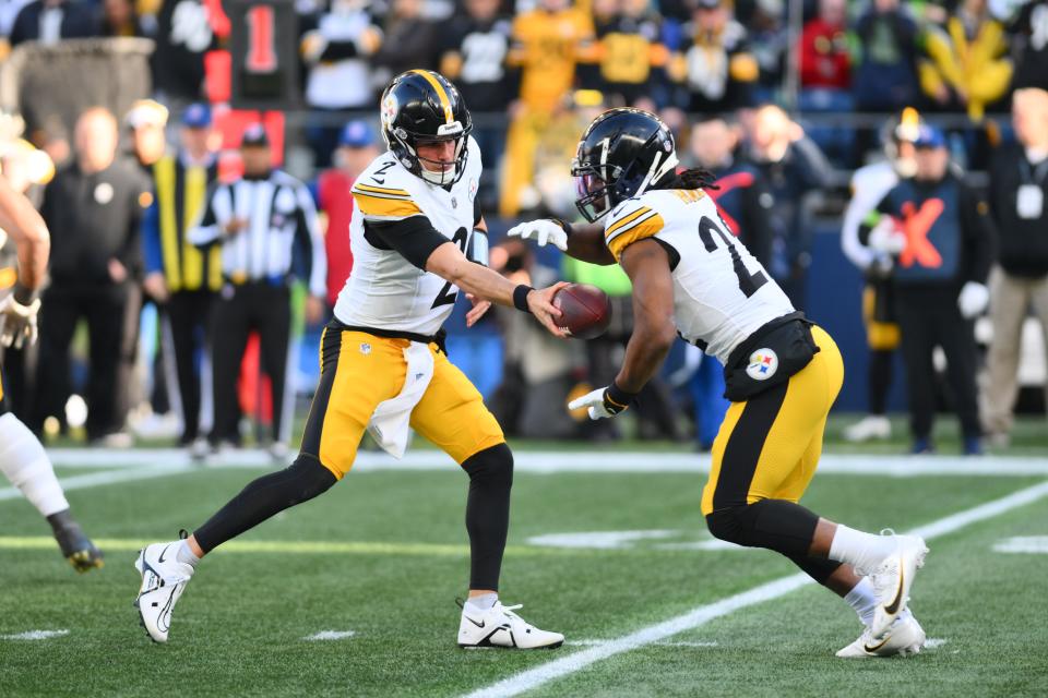 Pittsburgh Steelers quarterback Mason Rudolph (2) hands the ball off to Pittsburgh Steelers running back Najee Harris (22) during the first half against the Seattle Seahawks at Lumen Field.