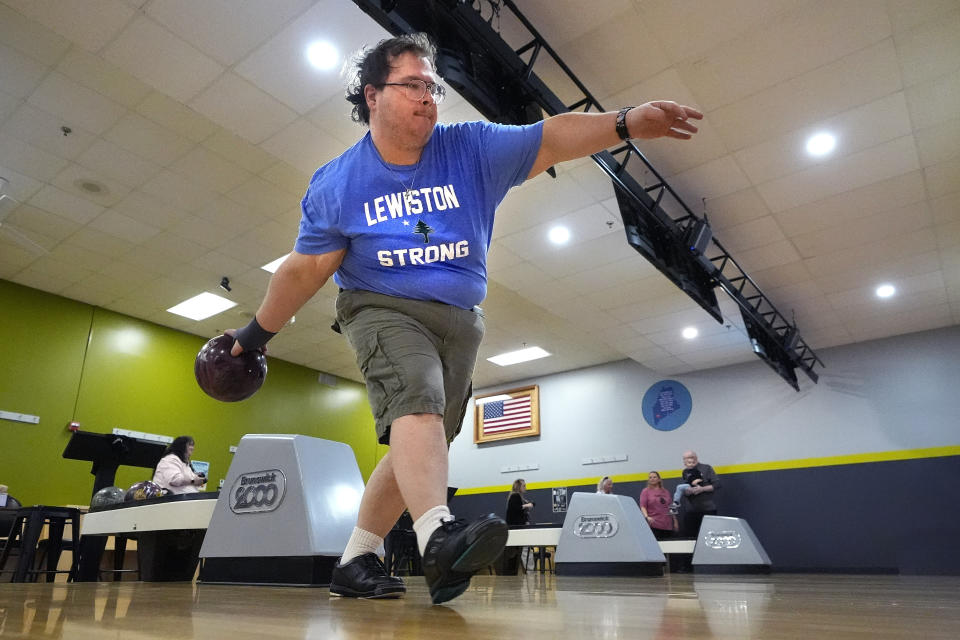 Josh Roy bowls at Just In Time Recreation, Friday, May 3, 2024, in Lewiston, Maine. The bowling alley, where eight people were killed in last October's mass shooting, reopened to the public on Friday. (AP Photo/Robert F. Bukaty)