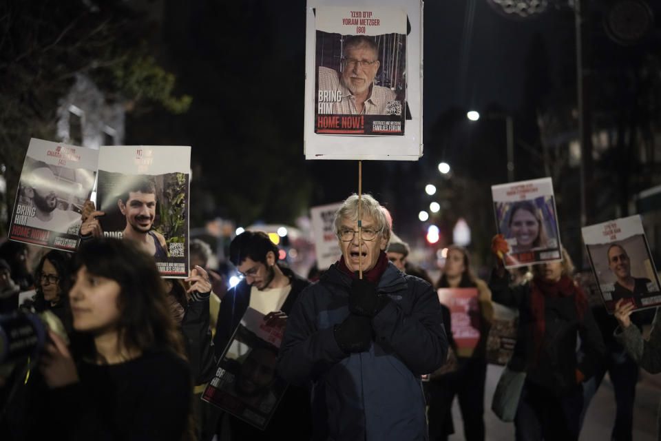 Demonstrators gather to protest Prime Minister Benjamin Netanyahu's reported decision to recall Israeli representatives from cease-fire negotiations, in Jerusalem, Wednesday, Feb. 14, 2024. The demonstrators saying the move endangers the lives of hostages held captive in Gaza. (AP Photo/Leo Correa)