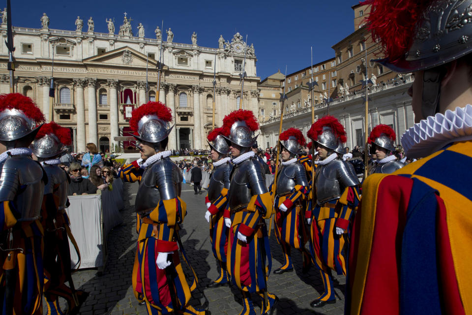 Vatican Swiss Guards parade in St. Peter's Square ahead of Pope Francis' Easter Sunday Mass in St. Peter's Square at the Vatican Sunday, April 20, 2014. Even before Mass began in late morning, more than 100,000 tourist, Romans and pilgrims, young and old, had turned out for the Mass. Many more streamed in throughout the ceremony, and the broad boulevard leading from the square to the Tiber river filled up with the faithful and the curious, trying to catch a glimpse of the pontiff at the altar under a canopy erected on the steps of St. Peter's Basilica. (AP Photo/Andrew Medichini)