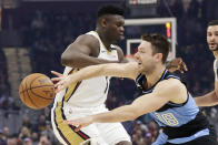 Cleveland Cavaliers' Matthew Dellavedova (18) passes the ball past New Orleans Pelicans' Zion Williamson (1) during the first half of an NBA basketball game Tuesday, Jan. 28, 2020, in Cleveland. (AP Photo/Tony Dejak)