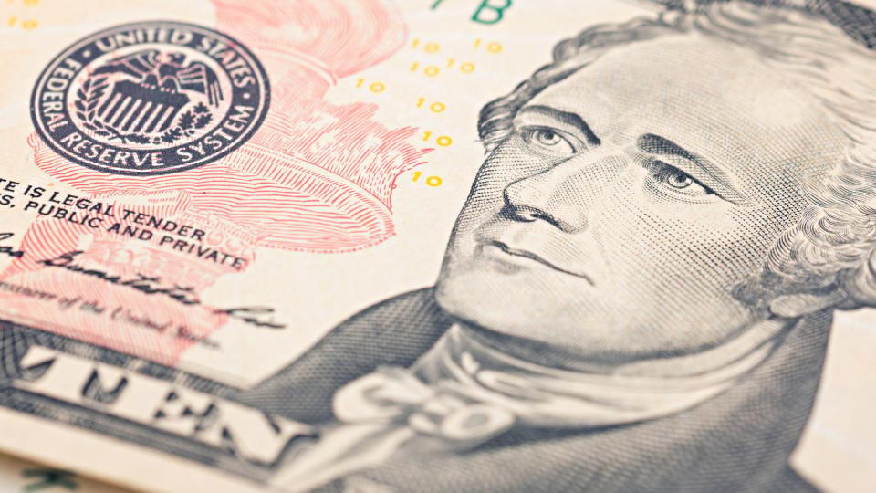 A close-up of Alexander Hamilton's portrait on a ten dollar bill. 