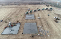 In this photo released by China's Xinhua News Agency, workers begin to build a medical isolation site that, according to state media, will cover 33 hectares and have room for several thousand people in Shijiazhuang in northern China's Hebei Province, Thursday, Jan. 14, 2021. China has put more than 20 million people under varying degrees of lockdown in Hebei, Beijing and other areas in hopes of stemming infections ahead of next month's Lunar New Year holiday. (Yang Shiyao/Xinhua via AP)