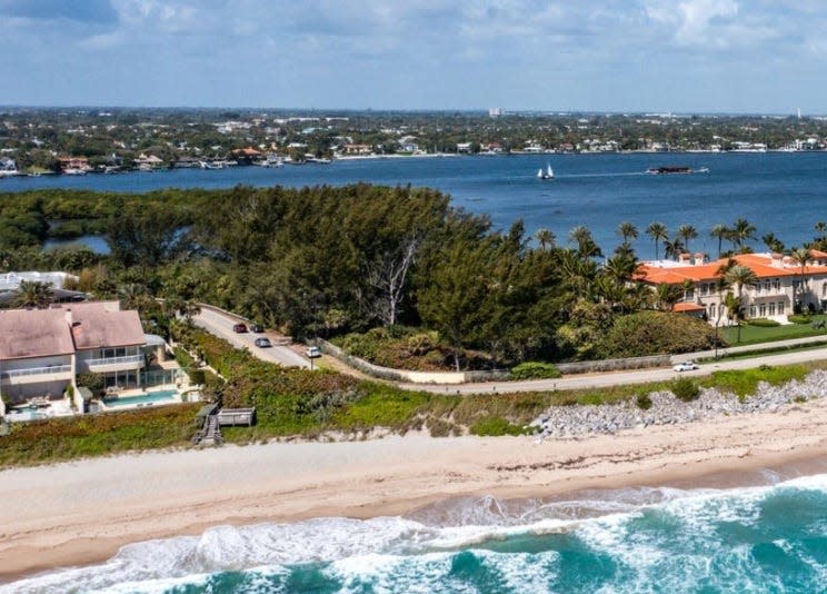 Covered in trees, a two-parcel, ocean-to-lake property bordering Sloan's Curve at 1980 S. Ocean Blvd. in Palm Beach is listed for sale at $150 million. Casino-and-resort billionaire Steve Wynn's house can be seen at the far right, with the red roof.