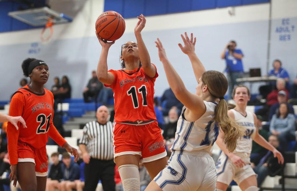 Beaver Falls Carla Brown (11) goes for a layup while being guarded by Ellwood City's Aliya Garroway during the first half Thursday night at Lincoln High School.