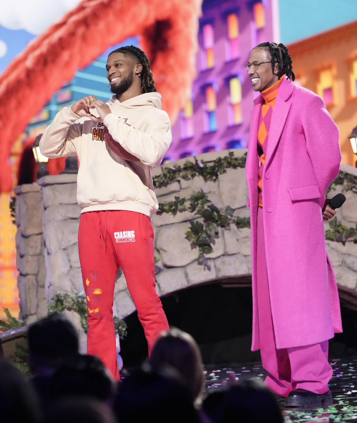 L-R: Damar Hamlin and host Nick Cannon in the “Sesame Street Night” episode of The Masked Singer.  (Pete Dadds / FOX)