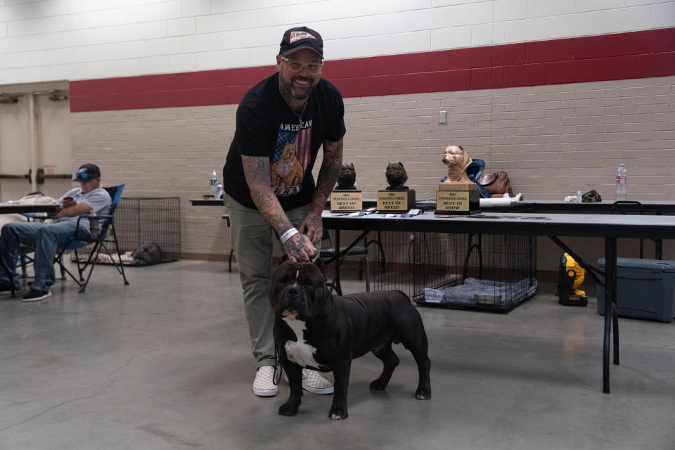 Lee Bullock with Grand Champion American Bully Hangman Saturday at the American Bully Kennel Club show at the Amarillo Civic Center.