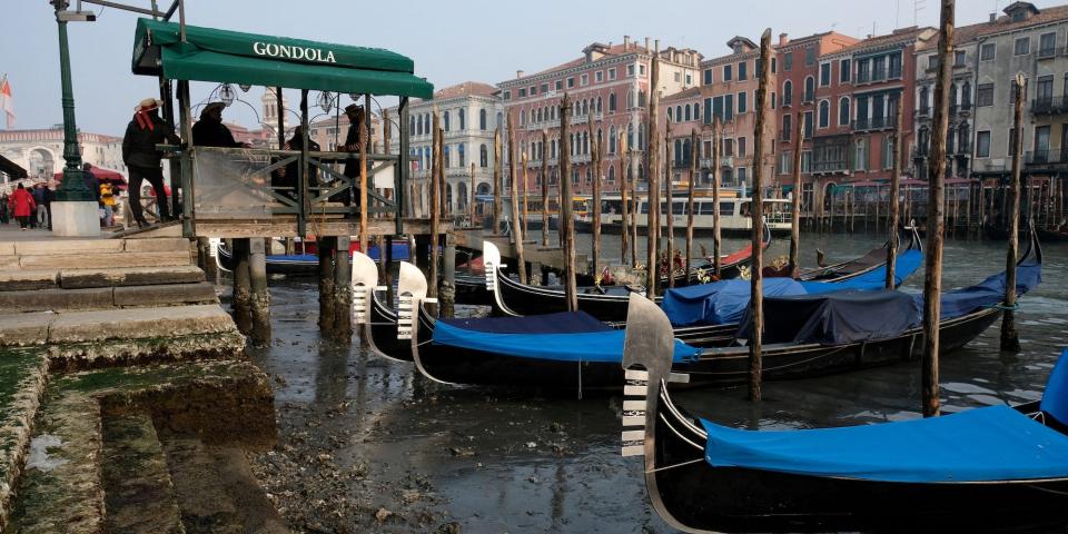 Gondolas parked at low tide in Venice on February 17, 2023, muddy steps show low water.