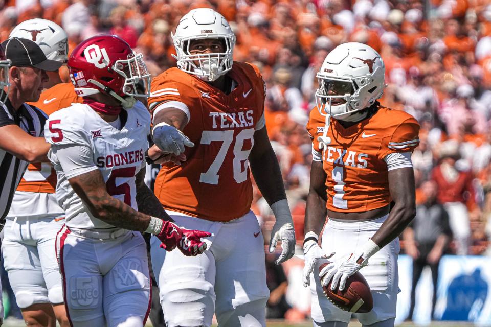 Texas left tackle Kelvin Banks Jr. gets between UT wide receiver Xavier Worthy and Oklahoma defensive back Woodi Washington during Saturday's game. The Sooners won 34-30 to improve to 6-0.