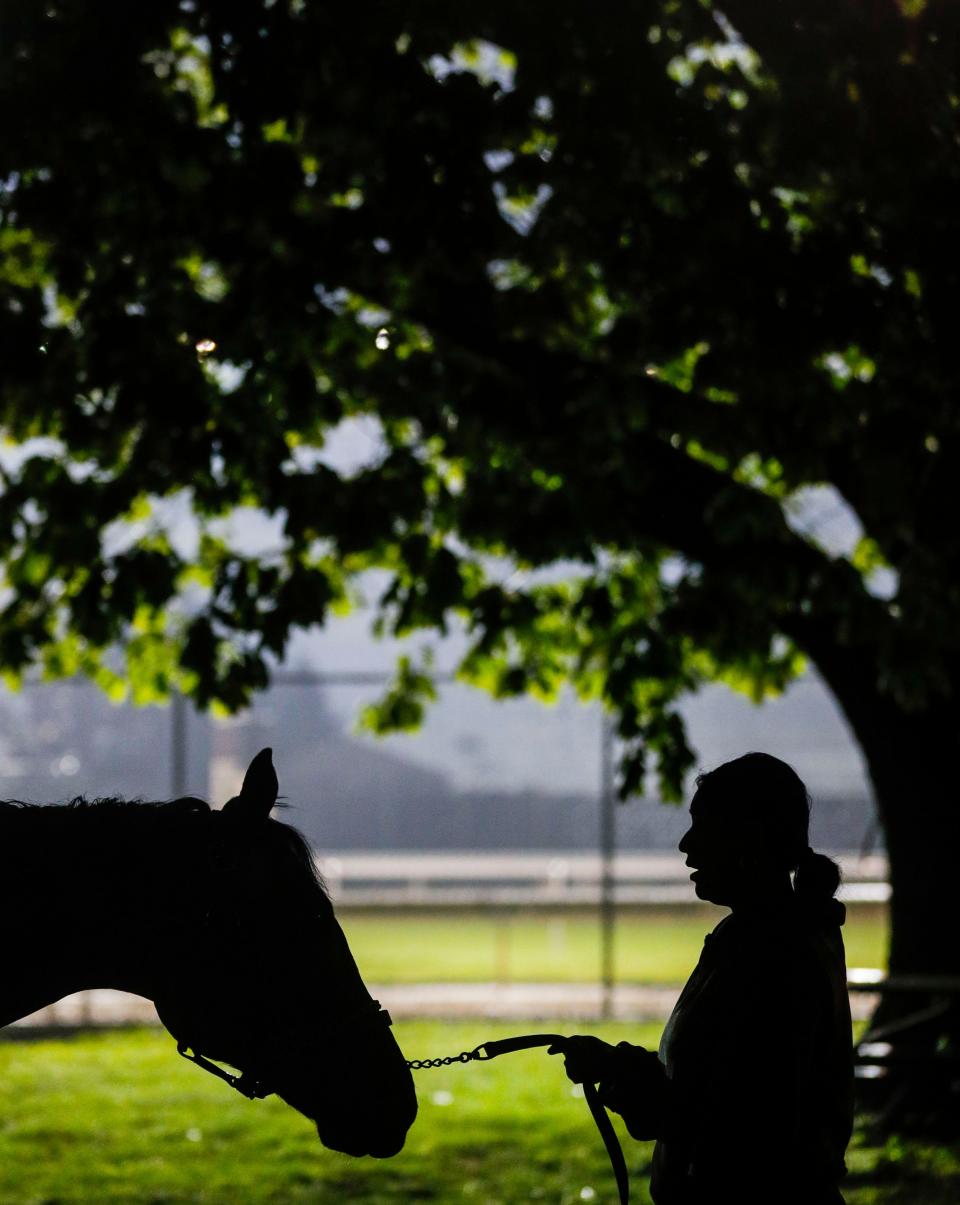 A horse and a stable employee stand outside in preparation for the day Friday morning, April 28, 2023 at Churchill Downs. 