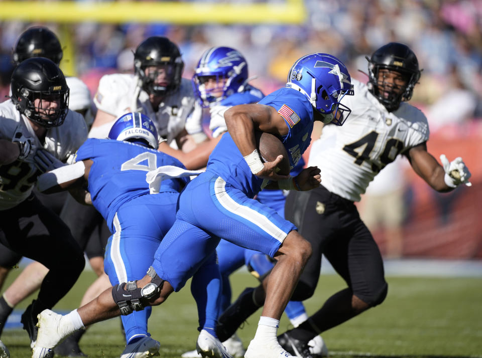 Air Force quarterback Zac Larrier, front, runs for a short gain against Army on in the second half of an NCAA college football game Saturday, Nov. 4, 2023, in Denver. (AP Photo/David Zalubowski)