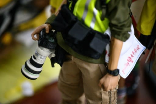 Among the 1:6 scale figures are journalists and white-collar workers