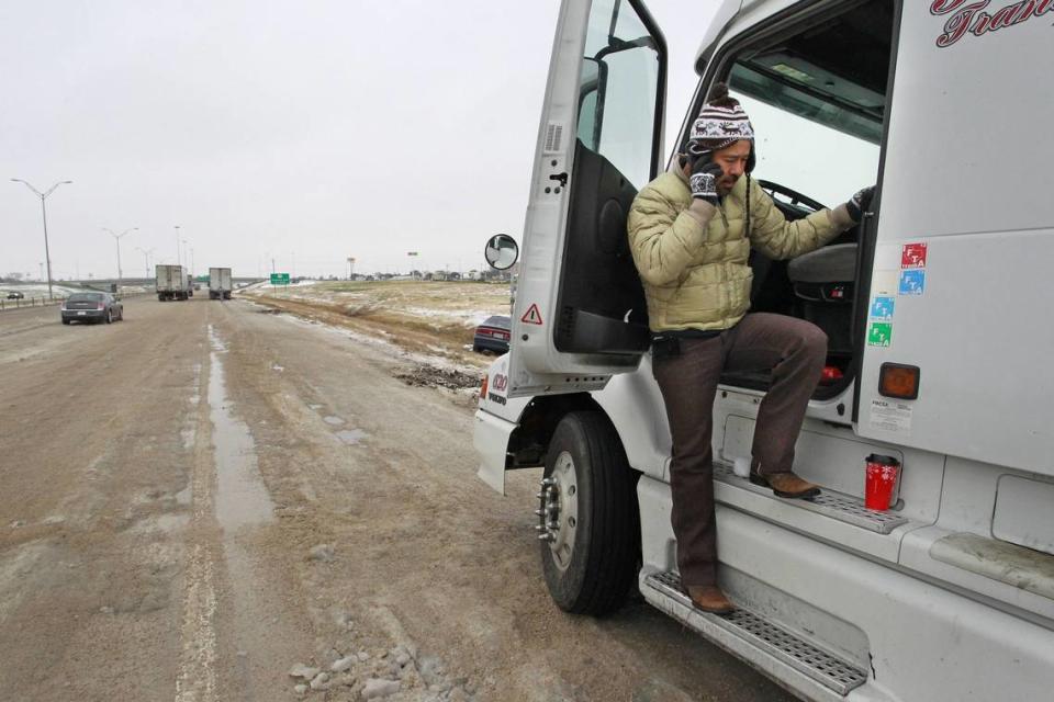 Trucker Alonso Medina and his semi stranded on the shoulder of I-20 (westbound) near Winscott in Benbrook. He was headed to Lubbock, and was on the phone with friends locally, hoping to find a place to stay while he sought to get his semi moving. Cold and ice remained in Fort Worth with roads especially treacherous in the the morning hours before temperatures rose, Sunday, Dec 8, 2013.