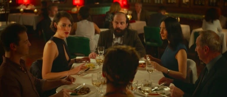 The characters of Fleabag sit around a table in a restaurant