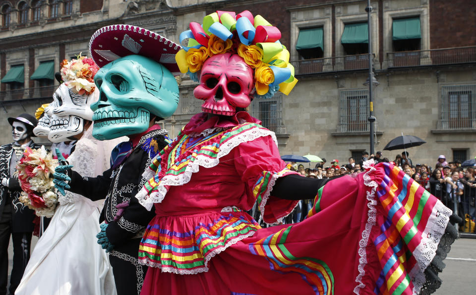Performers in costume attend a Day of the Dead parade in Mexico City, Sunday, Oct. 27, 2019. The parade on Sunday marks the fourth consecutive year that the city has borrowed props from the opening scene of the James Bond film, “Spectre,” in which Daniel Craig’s title character dons a skull mask as he makes his way through a crowd of revelers. (AP Photo/Ginnette Riquelme)