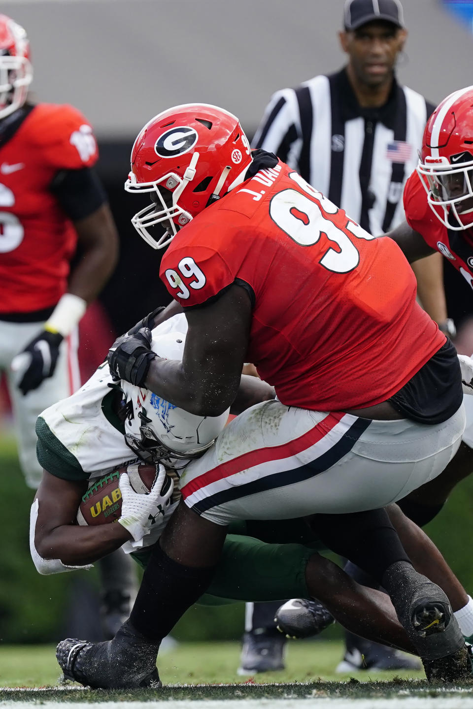 UAB running back Jermaine Brown Jr. (1) is stopped by Georgia defensive lineman Jordan Davis (99) during the first half of an NCAA college football game Saturday, Sept. 11, 2021, in Athens, Ga. (AP Photo/John Bazemore)