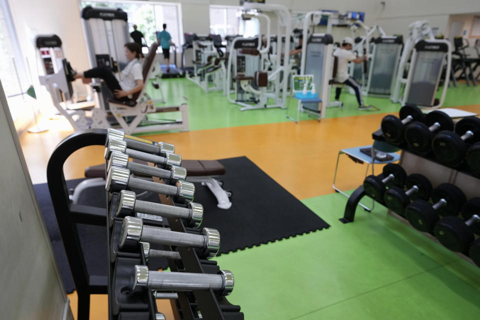 People work out at the Fukagawa Sports Center in Tokyo, Wednesday, June 12, 2024. (AP Photo/Hiro Komae)