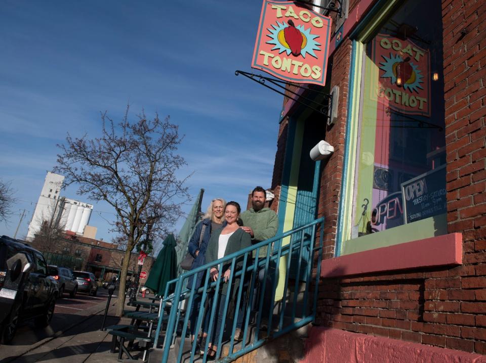 Former Taco Tontos owner Maureen Gartland joins current owners Emily and Kevin Yohn on Dec. 13 on the the steps of the Kent restaurant.