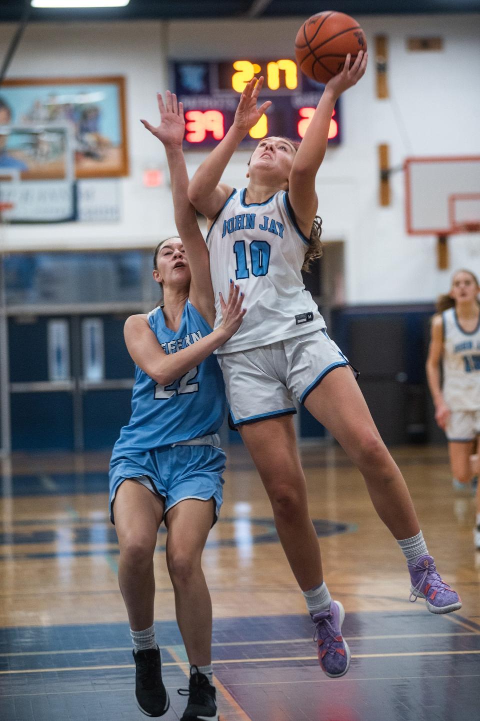 Suffern's Nicole DeBellis, left, attemps to block John Jay East Fishkill's Grace Kennedy, right, from shooting during the Section 1 girls basketball game at John Jay East Fishkill in Wiccopee, NY on Friday, February 17, 2023. John Jay East Fishkill defeated Suffern. KELLY MARSH/FOR THE POUGHKEEPSIE JOURNAL