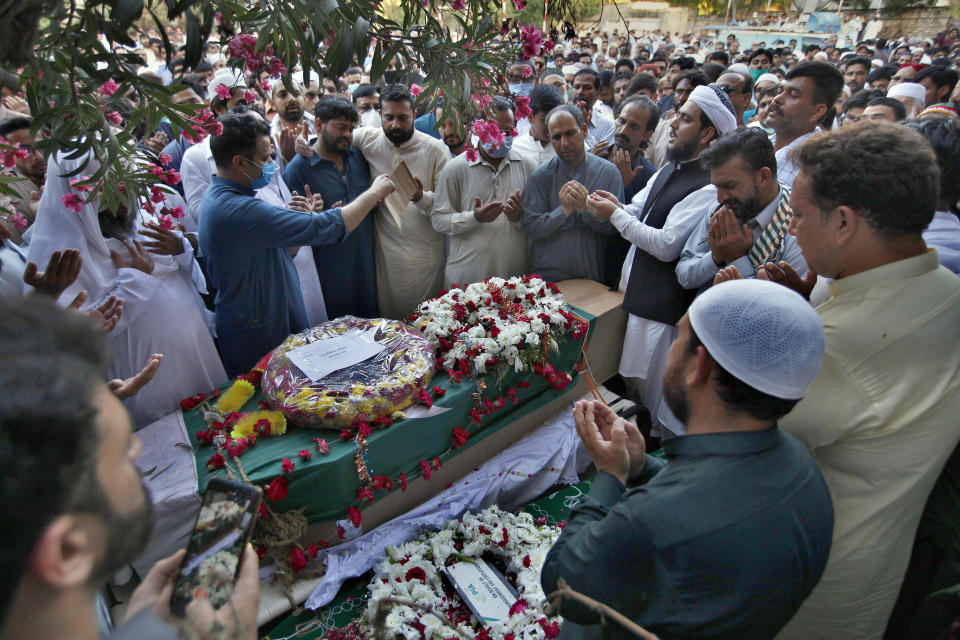 People attend the funeral for victims of the crash of a state-run Pakistan International Airlines plane on Friday near the southern port city of Karachi, in Rawalpindi, Pakistan, Monday, May 25, 2020. (AP Photo/Anjum Naveed)