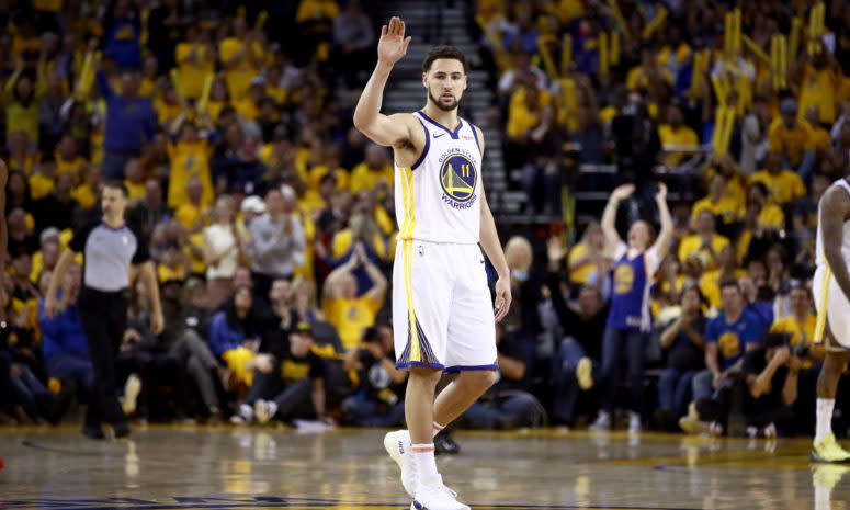 Klay Thompson waving to fans.