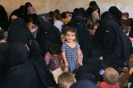 Families and relatives of Islamic State militants are see after they surrendered themselves to the Kurdish Peshmerga forces in al-Ayadiya, northwest of Tal Afar, Iraq August 30, 2017. REUTERS/Ari Jalal