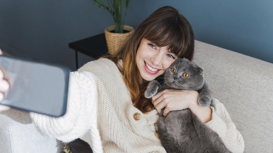 girl taking selfie with cat