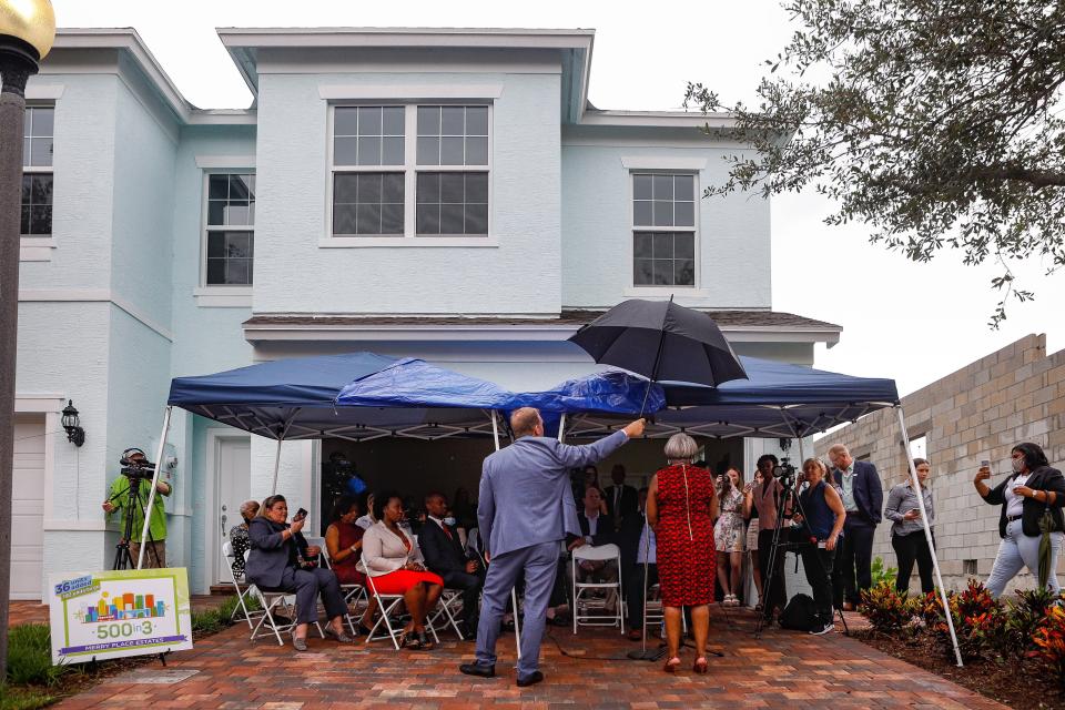 People attend an unveiling of 36 homes built under the City of West Palm Beach's workforce housing program in the Pleasant City neighborhood, June 17, 2021.