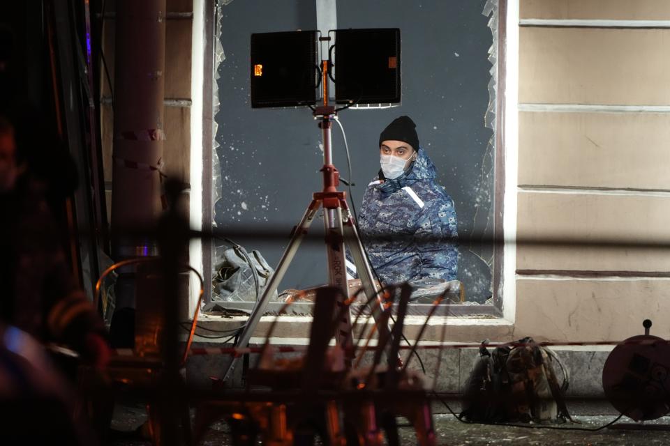 A Russian investigator works at the side of an explosion at a cafe in St. Petersburg, Russia, Sunday, April 2, 2023. An explosion tore through a cafe in the Russian city of St. Petersburg on Sunday, and preliminary reports suggested a prominent military blogger was killed and more than a dozen people were injured. (AP Photo)