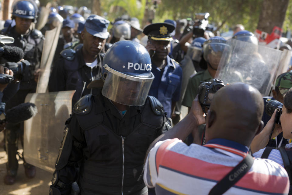 Riot police enter the Bronte hotel, where a press conference by opposition leader Nelson Chamisa was scheduled to take place, in Harare, Zimbabwe, Friday Aug. 3, 2018. Hours after President Emmerson Mnangagwa was declared the winner of a tight election, riot police disrupted a press conference where opposition leader Nelson Chamisa was about to respond to the election results. (AP Photo/Jerome Delay)