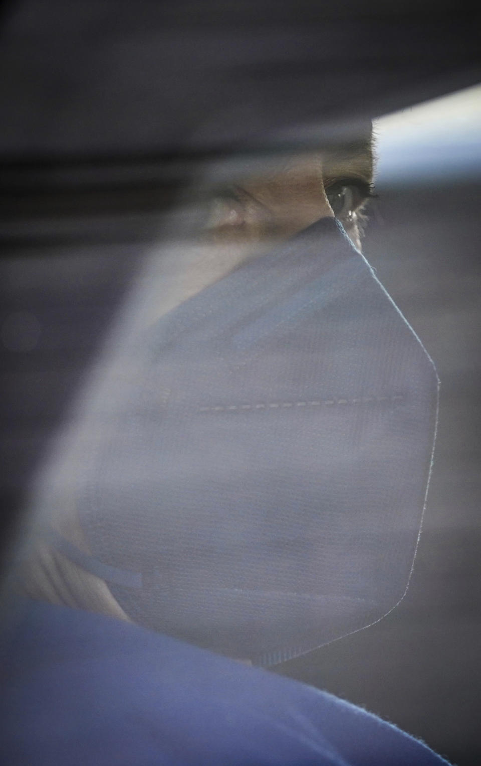 Chancellor Angela Merkel is driven away in her limousine after her vote in the Bundestag in Berlin, Germany, Thursday, May 6, 2021. In a roll-call vote, one item of the amendment to the Infection Protection Act was voted on. Earlier, the Bundestag decided on relief for vaccinated and recovered persons. (Michael Kappeler/dpa via AP)