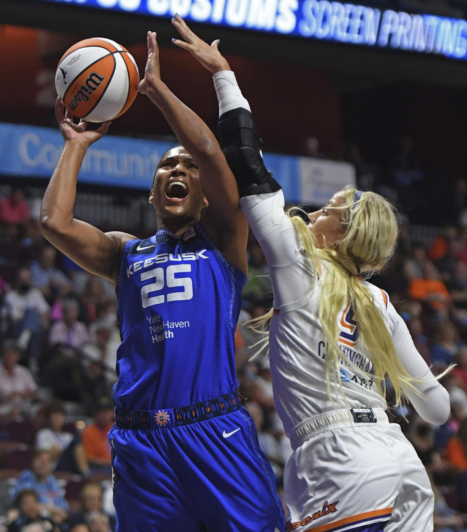 Phoenix Mercury guard Sophie Cunningham (9) fouls Connecticut Sun forward Alyssa Thomas (25)during a WNBA basketball game Tuesday, Aug. 2, 2022, in Uncasville, Conn. (Sean D. Elliot/The Day via AP)