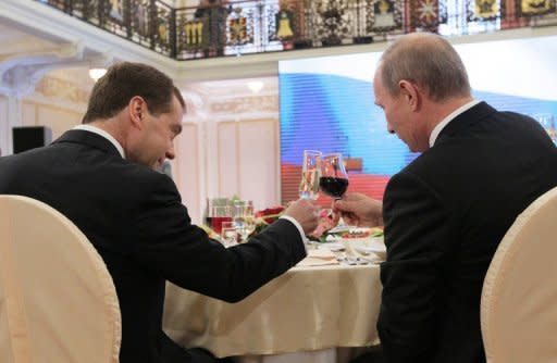 Russia's President Dmitry Medvedev (L) and Prime Minister Vladimir Putin toast each other during an award ceremony in Nizhny Novgorod. The upper house of Russia's parliament on Friday formally set March 4 as the date for the presidential election, a vote expected to see Vladimir Putin return to the top job