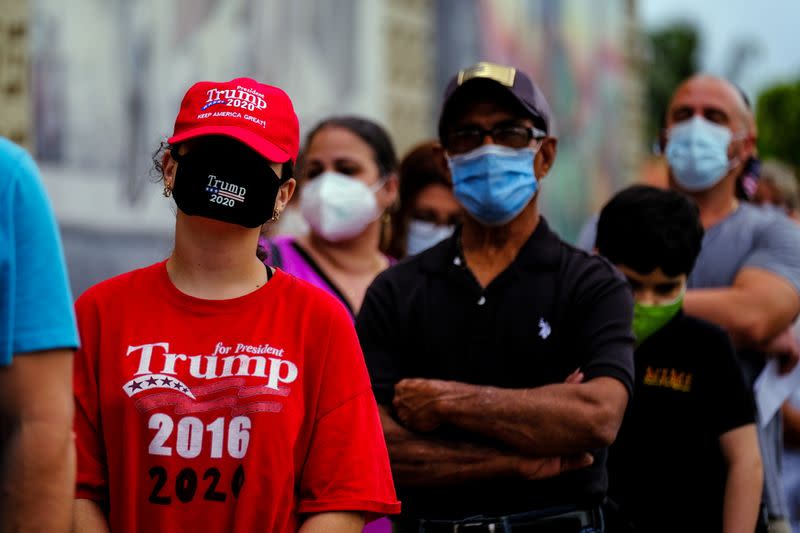 People line up at a polling station as early voting begins in Florida