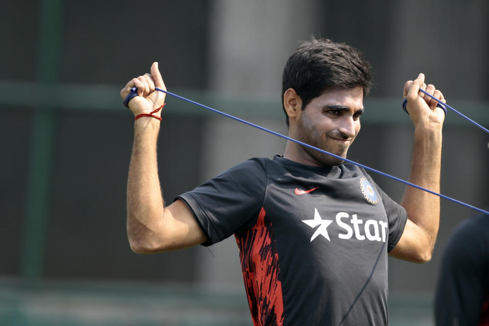 India’s Bhuvneshwar Kumar stretches during a practice session ahead of the Asia Cup tournament in Dhaka, Bangladesh, Monday, Feb. 24, 2014. Pakistan plays Sri Lanka in the opening match of the five nation one day cricket event that begins Tuesday. (AP Photo/A.M. Ahad)