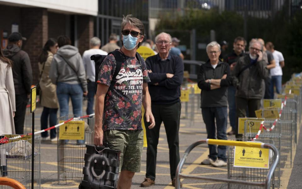 Customers practising social distancing after the B&Q store in Chiswick adopted safe measures to protect both customers and staff - Getty images