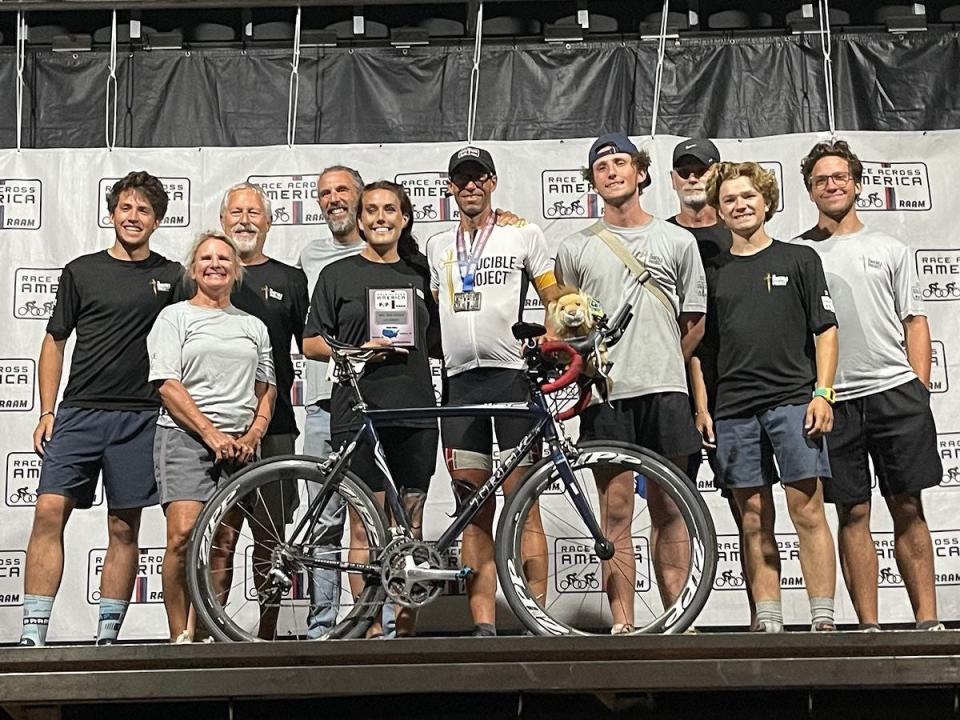 Les Crooks poses with his crew at the finish of the Race Across America in Maryland.