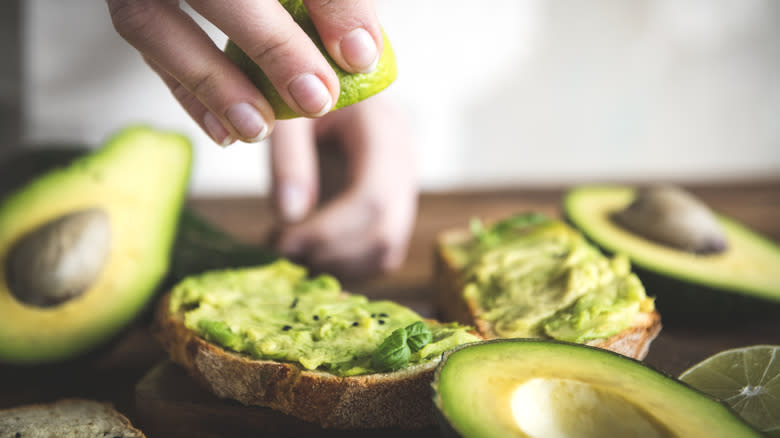 squeezing lime onto avocado