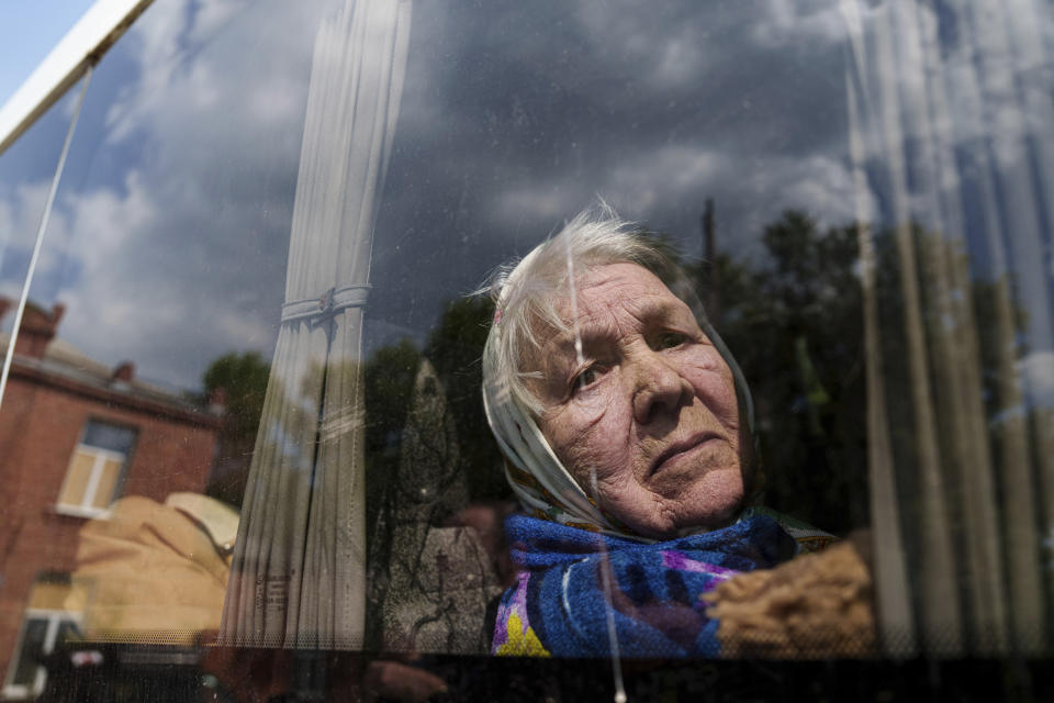 Liudmila, 85, looks though the window of a bus after being evacuated from Vovchansk, Ukraine, Sunday, May 12, 2024. Her husband was killed in their house after a Russian airstrike on the city. (AP Photo/Evgeniy Maloletka)