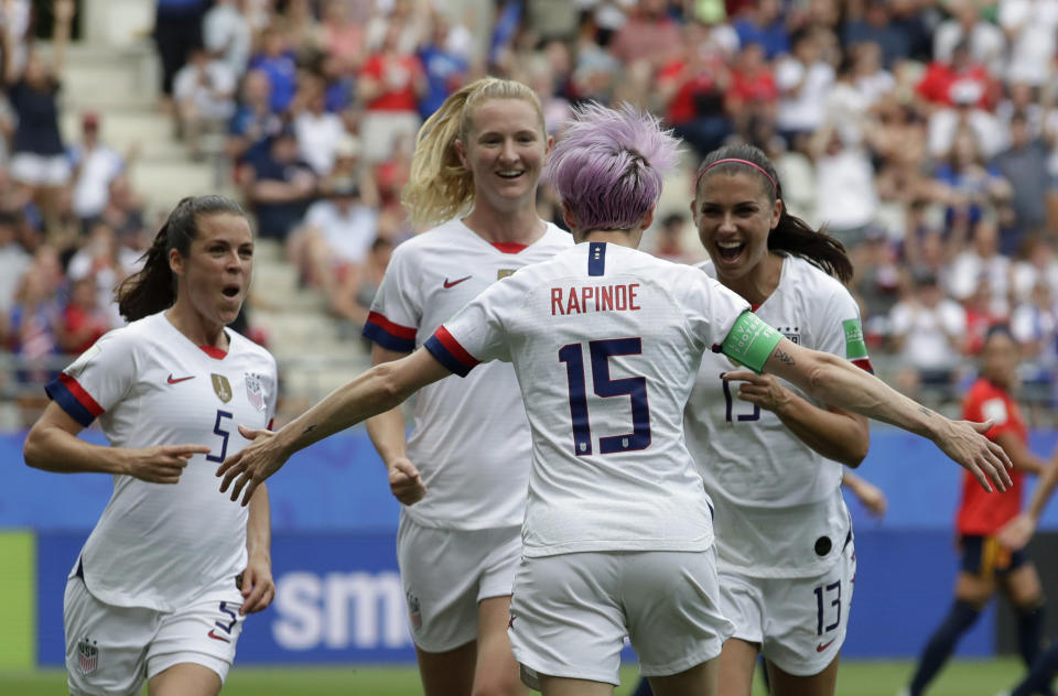 United States' Megan Rapinoe, front, celebrates with teammates after scoring the opening goal from a penalty kick during the Women's World Cup round of 16 soccer match between Spain and US at the Stade Auguste-Delaune in Reims, France, Monday, June 24, 2019. (AP Photo/Alessandra Tarantino)