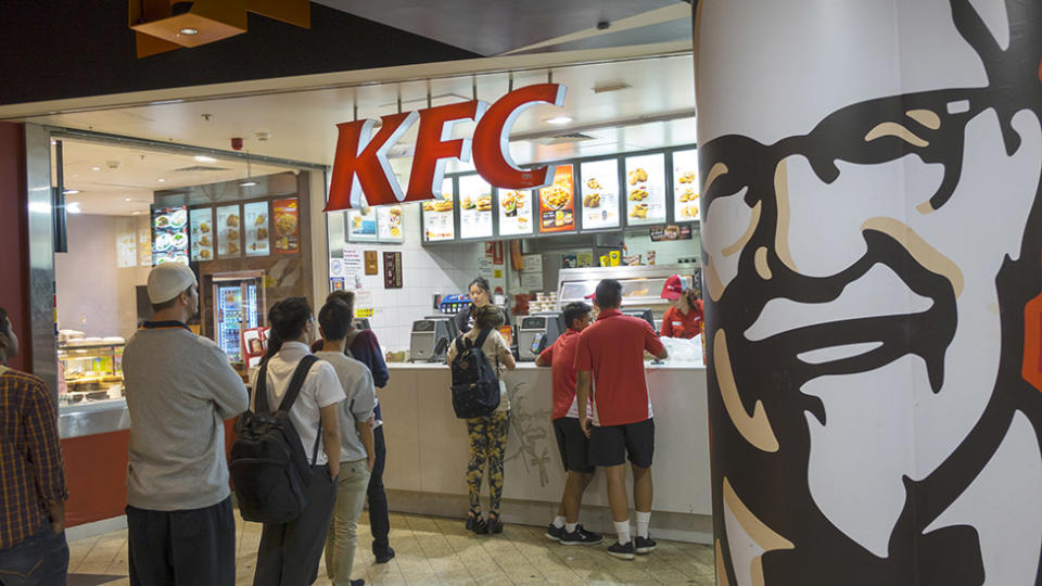 Customers queue at KFC which closes dining rooms in Australia as COVID-19 prevention measure