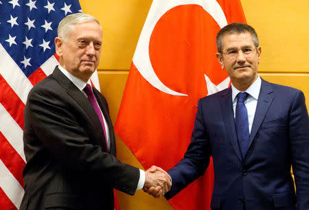 U.S. Secretary of Defence Jim Mattis poses with Turkish Defence Minister Nurettin Canikli during a NATO defence ministers meeting at the Alliance headquarters in Brussels, Belgium, February 14, 2018. REUTERS/Virginia Mayo/Pool