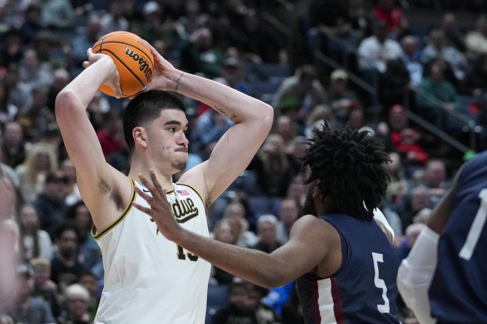 Fairleigh Dickinson forward Ansley Almonor (5) defends Purdue center Zach Edey (15) in the second half of a first-round college basketball game in the men's NCAA Tournament in Columbus, Ohio, Friday, March 17, 2023. (AP Photo/Michael Conroy)