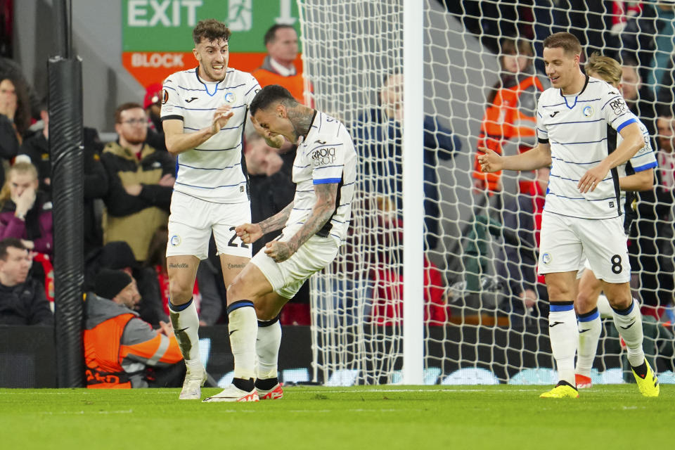 Atalanta's Gianluca Scamacca, second from left, celebrates scoring his side's opening goal during the Europa League quarter final first leg soccer match between Liverpool and Atalanta, at the Anfield stadium in Liverpool, England, Thursday, April 11, 2024. (AP Photo/Jon Super)