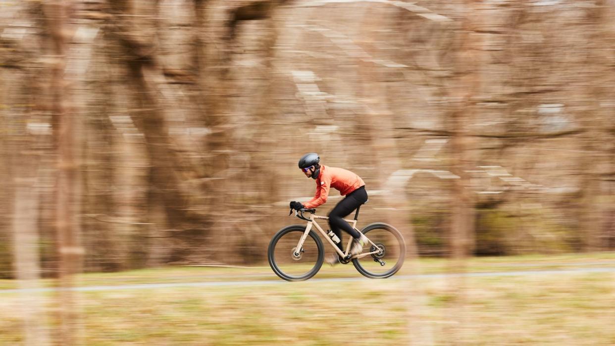 a person riding a bike fast on a path