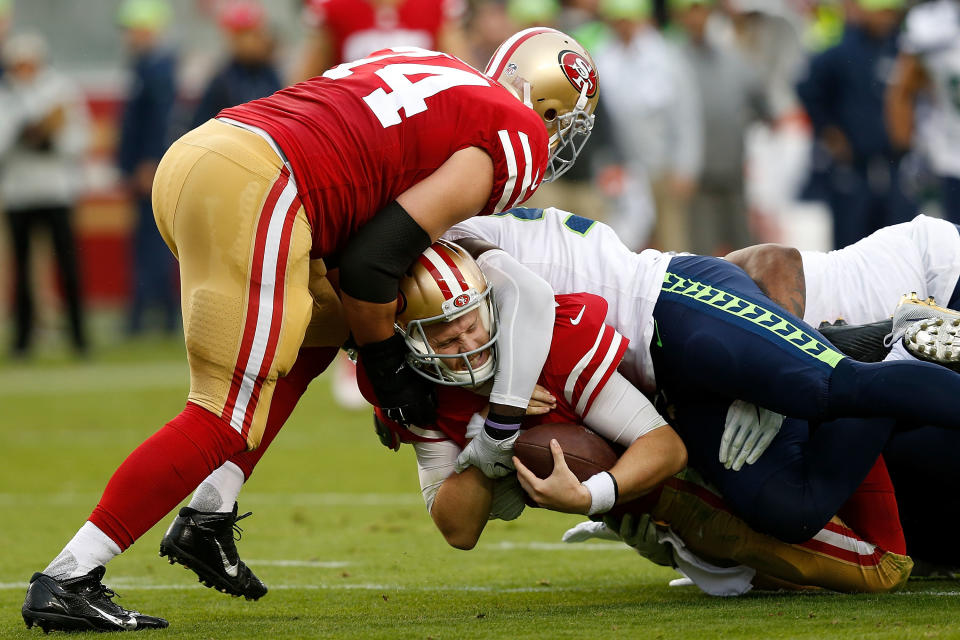 <p>C.J. Beathard #3 of the San Francisco 49ers is tackled by Frank Clark #75 of the Seattle Seahawks at Levi’s Stadium on November 26, 2017 in Santa Clara, California. (Photo by Lachlan Cunningham/Getty Images) </p>