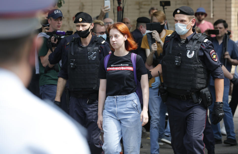 Police officers detain a protester wearing a T-shirt reading "Freedom to Safronov" during a rally to support Ivan Safronov near the Lefortovo prison in Moscow, Russia, Monday, July 13, 2020. Safronov, an ex-journalist who worked as an adviser to the director of Russia's state space corporation has been arrested and jailed on charges of passing military secrets to Czech intelligence. Ivan Safronov wrote about military and security issues before becoming an adviser to the head of Roscosmos. (AP Photo/Alexander Zemlianichenko)